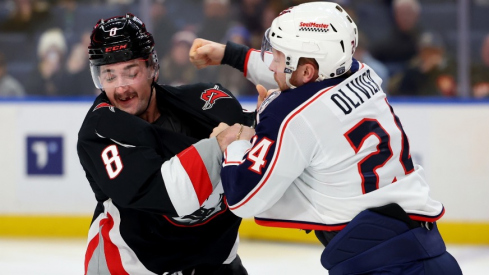 Buffalo Sabres defenseman Dennis Gilbert (8) and Columbus Blue Jackets right wing Mathieu Olivier (24) fight during the first period at KeyBank Center.