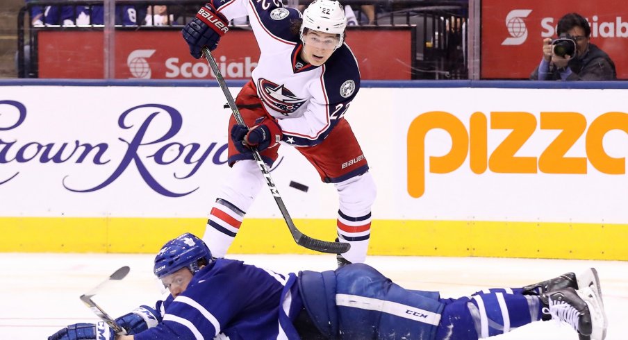 Sonny Milano tries to saucer a pass over a Leafs defenseman