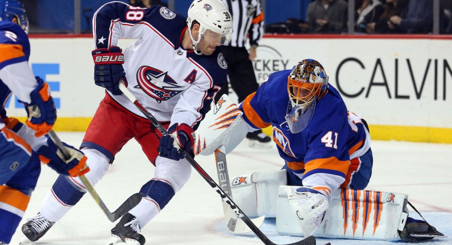 Boone Jenner tries to beat Islanders goaltender Jaroslav Halak