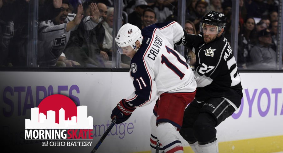 Matt Calvert tries to keep the puck away from Kings defenseman Alec Martinez