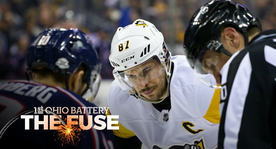 Alexander Wennberg faces off against Sidney Crosby at Nationwide Arena.