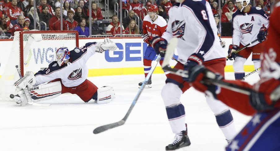 Joonas Korpisalo makes a save on Washington Capitals defenseman John Carlson in the first period at Capital One Arena