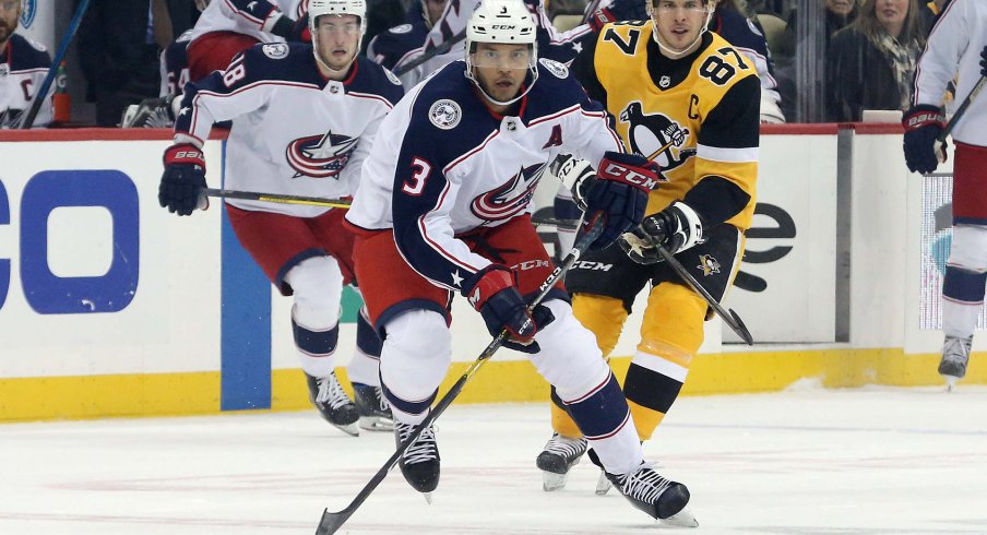 Columbus Blue Jackets defenseman Seth Jones (3) skates up ice with the puck ahead of Pittsburgh Penguins center Sidney Crosby (87) during the first period at PPG PAINTS Arena.