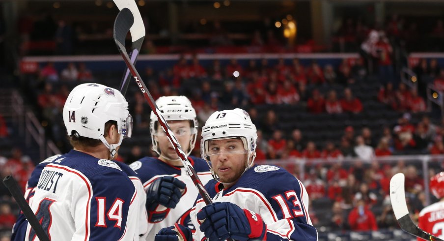 Dec 9, 2019; Washington, DC, USA; Columbus Blue Jackets right wing Cam Atkinson (13) celebrates with teammates after scoring a goal against the Washington Capitals in the first period at Capital One Arena. Mandatory Credit: Geoff Burke-USA TODAY Sports