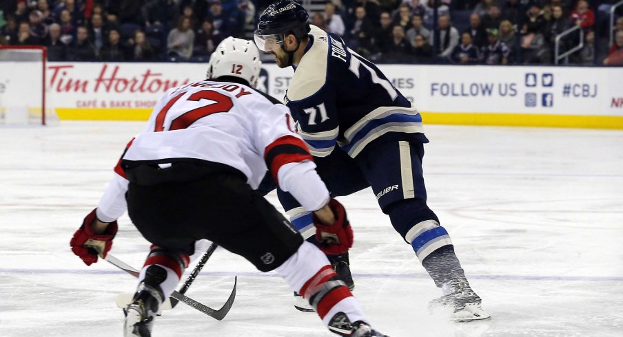 Dec 20, 2018; Columbus, OH, USA; Columbus Blue Jackets left wing Nick Foligno (71) passes the puck as New Jersey Devils defenseman Ben Lovejoy (12) defends during the second period at Nationwide Arena.