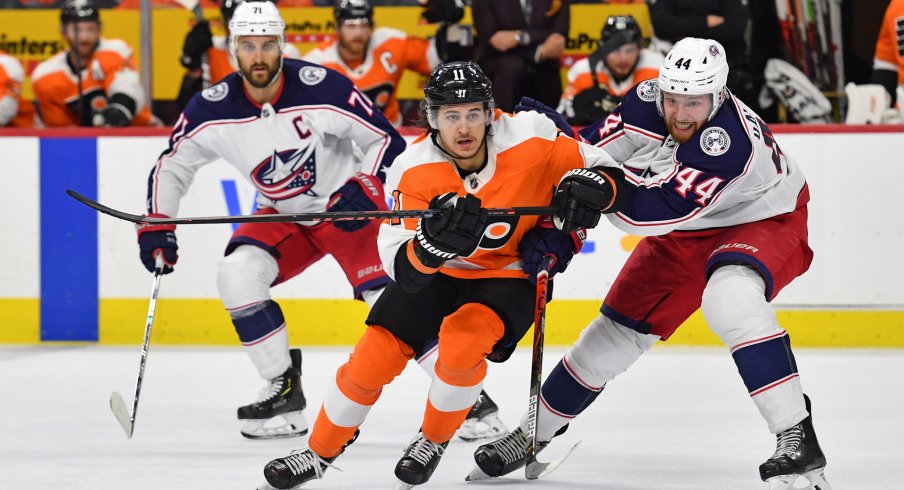 Feb 18, 2020; Philadelphia, Pennsylvania, USA; Philadelphia Flyers right wing Travis Konecny (11) and Columbus Blue Jackets defenseman Vladislav Gavrikov (44) battle for the puck during the second period during the first period at Wells Fargo Center.