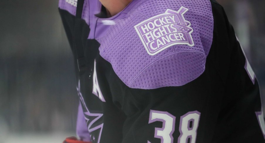 Nov 15, 2019; Columbus, OH, USA; A view of the Hockey Fights Cancer logo on the jersey of Columbus Blue Jackets center Boone Jenner (38) as he skates during warmups prior to the game against the St. Louis Blues at Nationwide Arena.