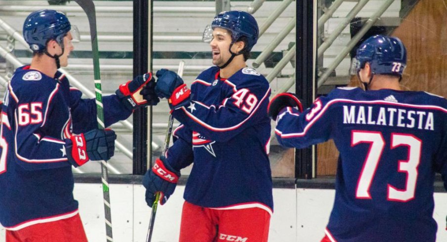 Blue Jackets prospects celebrate a goal.