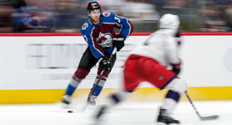 Columbus Blue Jackets defenseman Scott Harrington (4) defends against Colorado Avalanche left wing J.T. Compher (37) in the second period at the Pepsi Center. 