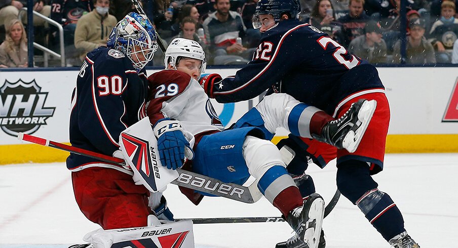 Columbus Blue Jackets goalie Elvis Merzlikins (90) makes a save against Colorado Avalanche center Nathan MacKinnon (29)