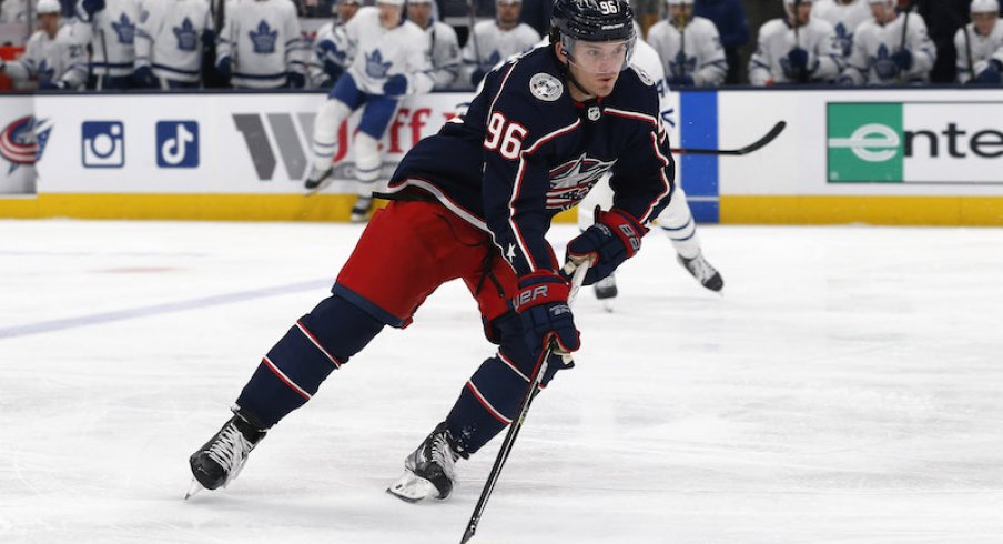 Columbus Blue Jackets' Jack Roslovic playing the puck against the Toronto Maple Leafs at Nationwide Arena.