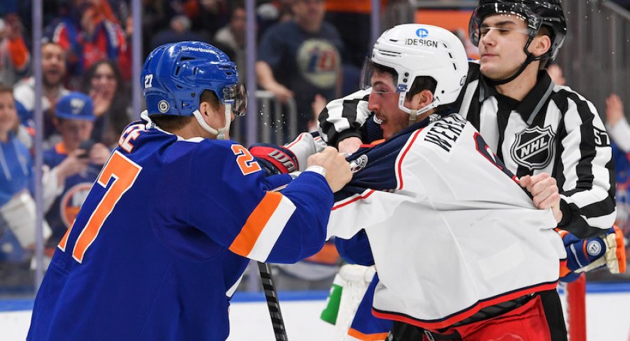 New York Islanders' Anders Lee and Columbus Blue Jackets' Zach Werenski mix it up during a game at UBS Arena.