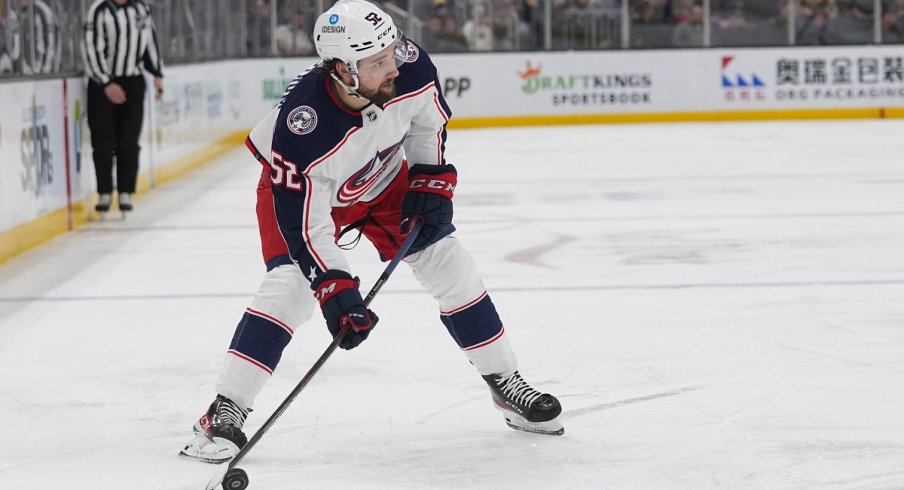 Emil Bemstrom skates with the puck against the Boston Bruins