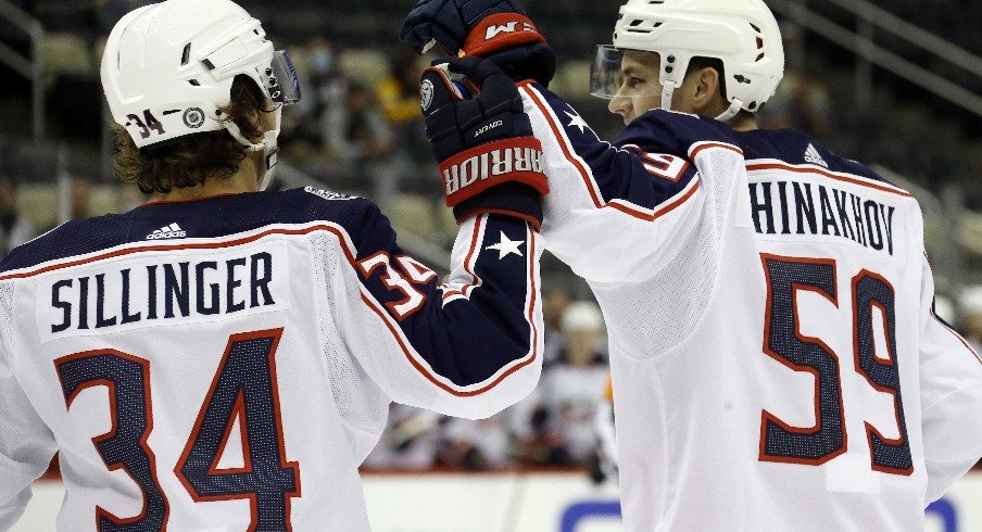 Columbus Blue Jackets forward Yegor Chinakhov celebrates with forward Cole Sillinger after scoring a goal against the Pittsburgh Penguins during the first period at PPG Paints Arena.