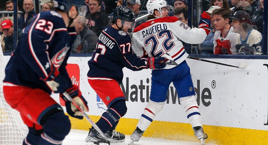 Columbus Blue Jackets defenseman Nick Blankenburg (77) checks Montreal Canadiens right wing Cole Caufield (22) during the first period at Nationwide Arena.