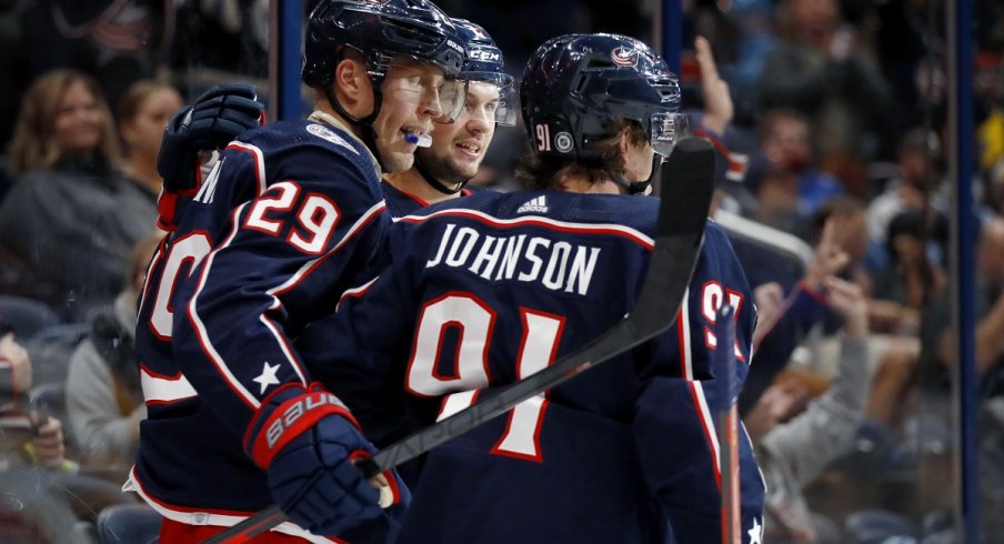 Patrik Laine celebrates a goal with Kent Johnson and Andrew Peeke