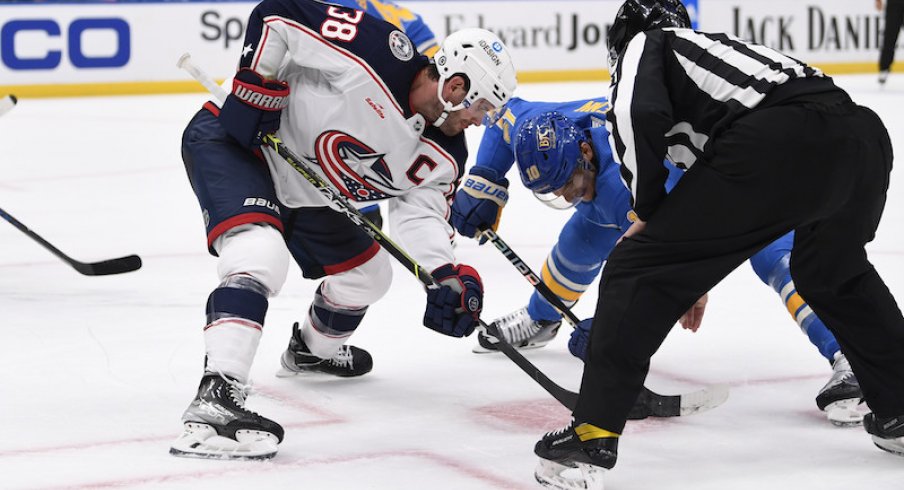 Columbus Blue Jackets' Boone Jenner takes the face-off against St. Louis Blues center Brayden Schenn during the second period at Enterprise Center.