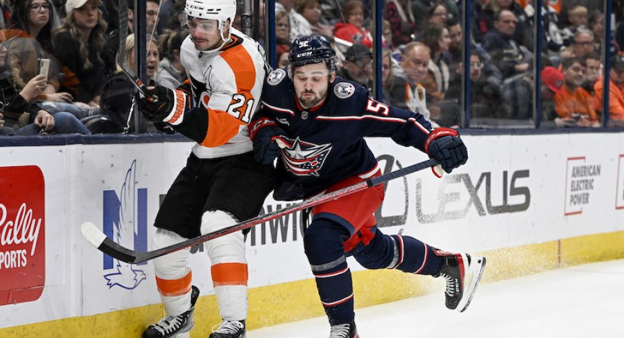 Columbus Blue Jackets' Emil Bemstrom checks Philadelphia Flyers' Scott Laughton against the boards in the second period at Nationwide Arena.