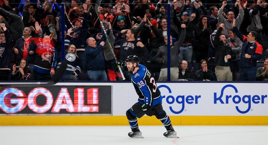 Columbus Blue Jackets center Boone Jenner celebrates the empty net goal by center Sean Kuraly in the game against the Calgary Flames in the third period at Nationwide Arena.