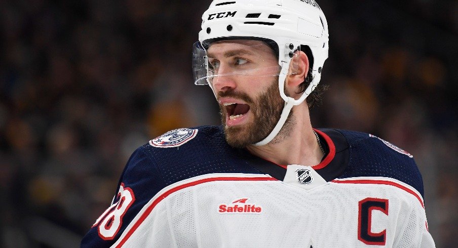 Columbus Blue Jackets center Boone Jenner has words with one of the Boston Bruins during the second period at TD Garden.