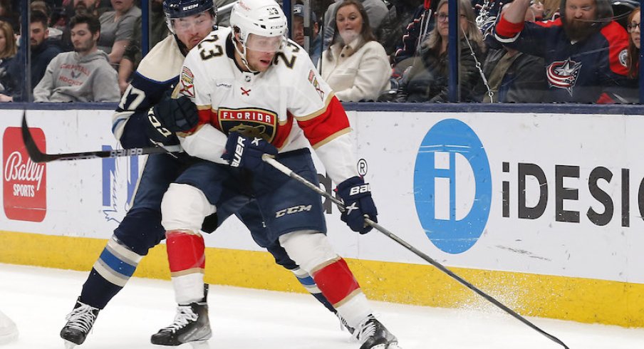 Columbus Blue Jackets' Marcus Bjork and Florida Panthers' Carter Verhaeghe battle for a loose during the first period at Nationwide Arena.