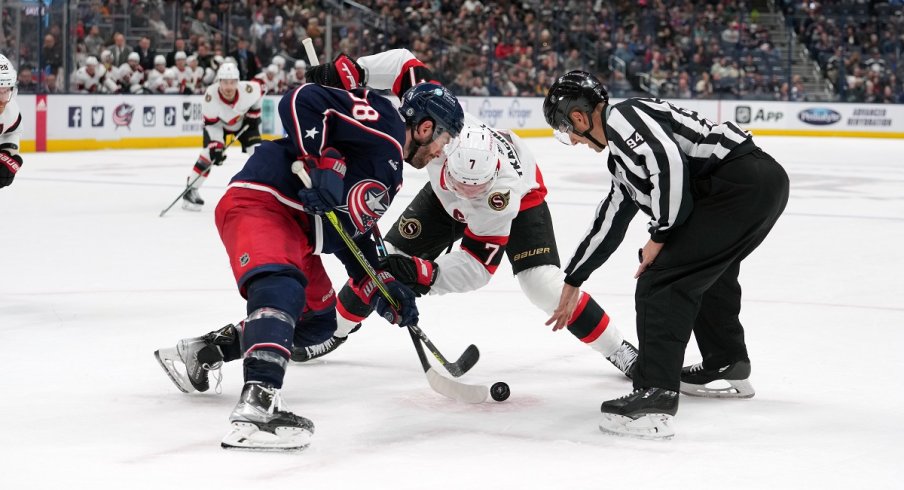 Boone Jenner and Brady Tkachuk face-off at Nationwide Arena