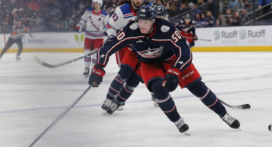 Columbus Blue Jackets' Eric Robinson gains control of a loose puck as New York Rangers Mika Zibanejad trails the play during the second period at Nationwide Arena.