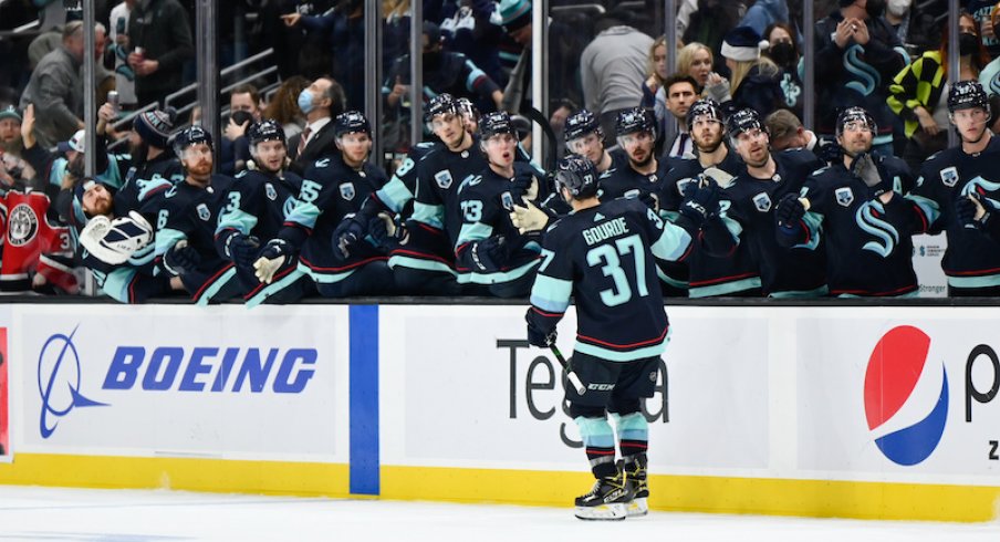 Seattle Kraken's Yanni Gourde celebrates with the bench after scoring a goal against the Calgary Flames during the third period at Climate Pledge Arena.