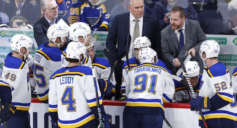 St. Louis Blues Head Coach Craig Berube watches St. Louis Blues Assistant Coach Steve Ott discuss a play during a time out in the third period against the Winnipeg Jets at Canada Life Centre.