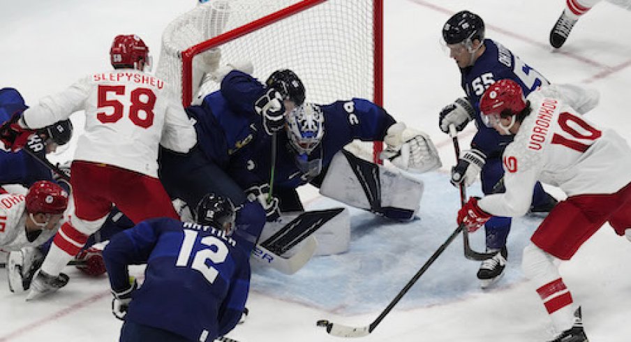 Team ROC forward Dmitri Voronkov (10) attempts to shoot the puck on Team Finland goalkeeper Harri Sateri (29) in the third period during the Beijing 2022 Olympic Winter Games at National Indoor Stadium.