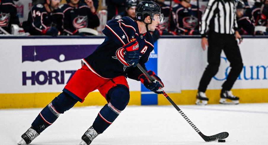 Columbus Blue Jackets defenseman Zach Werenski (8) skates with the puck against the Philadelphia Flyers in the first period at Nationwide Arena.