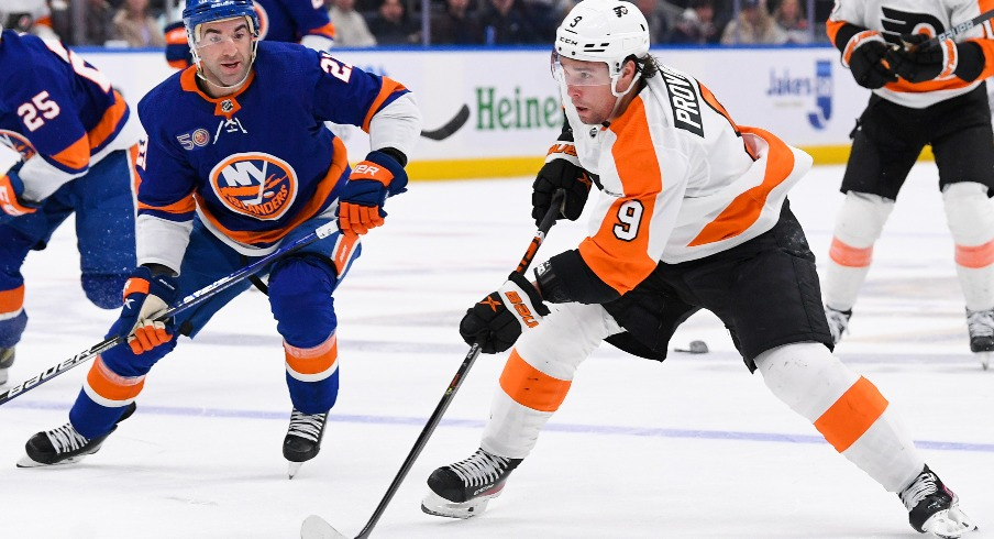 Philadelphia Flyers defenseman Ivan Provorov (9) skates with the puck defended by New York Islanders center Kyle Palmieri (21) during the first period at UBS Arena.