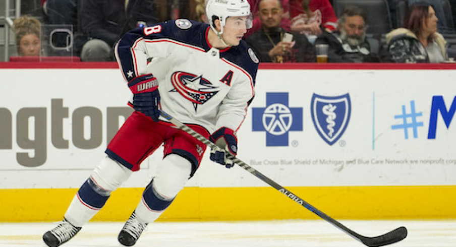 Columbus Blue Jackets defenseman Zach Werenski (8) skates with the puck during the second period against the Detroit Red Wings at Little Caesars Arena.