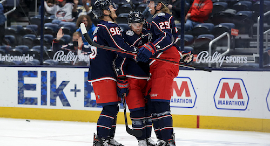 Columbus Blue Jackets right wing Cam Atkinson (middle) celebrates with teammates center Jack Roslovic (left) and right wing Patrik Laine (right) after scoring a goal against the Detroit Red Wings in the 1st period at Nationwide Arena.