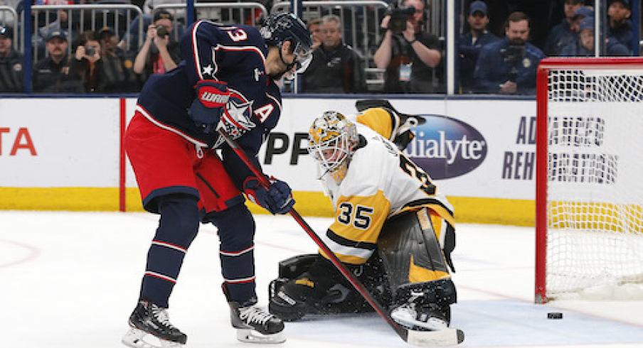 Columbus Blue Jackets left wing Johnny Gaudreau (13) scores a goal against Pittsburgh Penguins goalie Tristan Jarry (35) during overtime at Nationwide Arena.