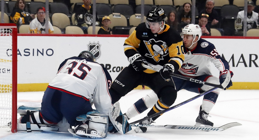 Columbus Blue Jackets defenseman David Jiricek defends Pittsburgh Penguins left wing Drew O'Connor