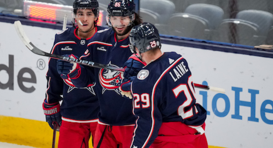 Columbus Blue Jackets left wing Kirill Marchenko, middle, celebrates with teammates left wing Johnny Gaudreau (13) and right wing Patrik Laine (29) after scoring a goal against the St. Louis Blues in the first period at Nationwide Arena.