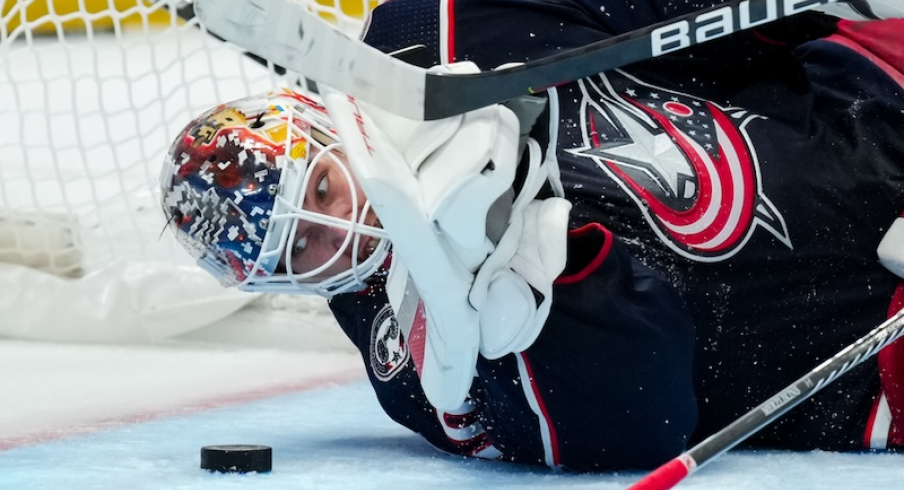 Columbus Blue Jackets' Elvis Merzlikins eyes the puck as he dives to make a save in net against the Philadelphia Flyers in the second period at Nationwide Arena.