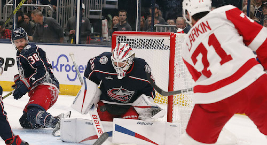 Columbus Blue Jackets goalie Spencer Martin (30) makes a save on the shot from Detroit Red Wings center Dylan Larkin (71) during the first period at Nationwide Arena.