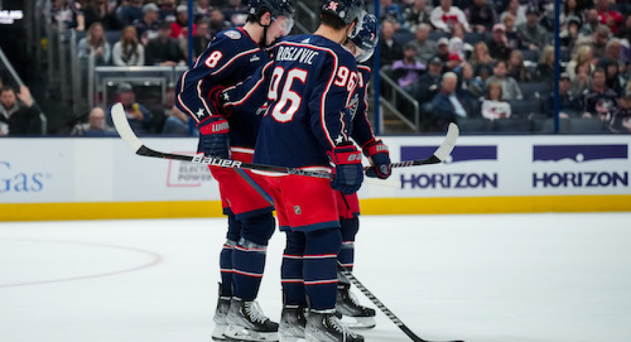 Columbus Blue Jackets defenseman Zach Werenski (8) is helped off the ice by teammates center Jack Roslovic (96) and center Sean Kuraly (7) during a stop in play against the Philadelphia Flyers in the second period at Nationwide Arena.