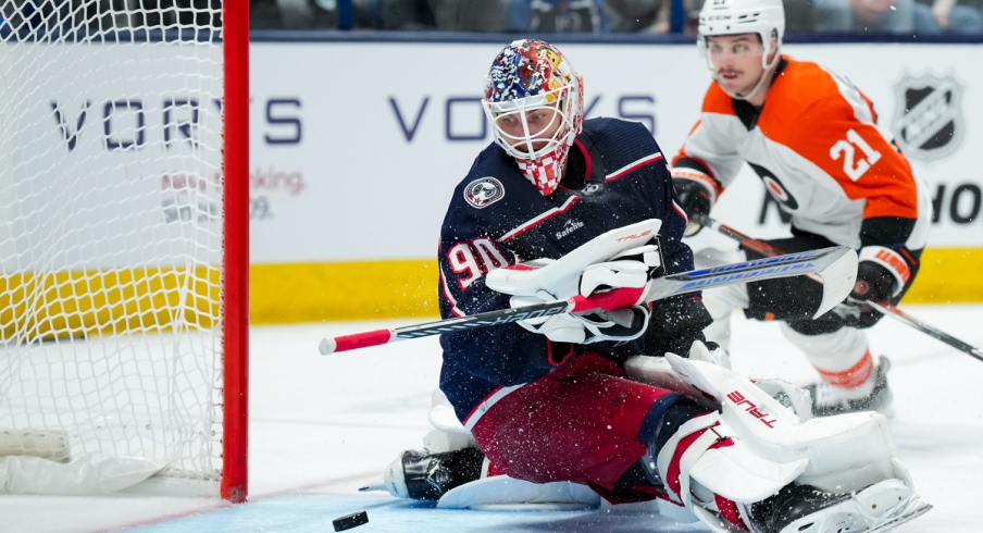 Columbus Blue Jackets goalie Elvis Merzlikins lunges for a puck