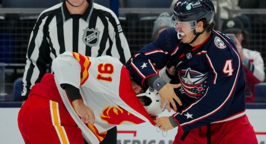 Calgary Flames center Nazem Kadri (91) fights Columbus Blue Jackets center Cole Sillinger (4) in the first period at Nationwide Arena.