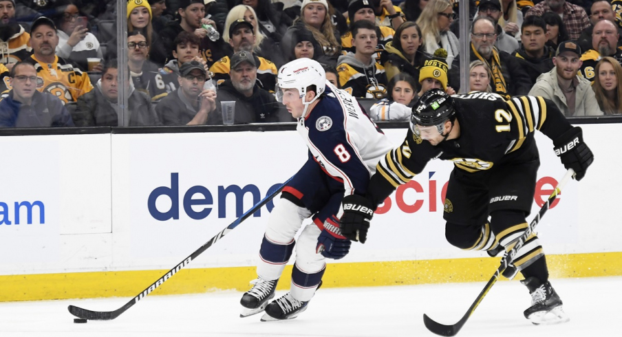 Zach Werenski skates past Boston Bruins defenseman Kevin Shattenkirk