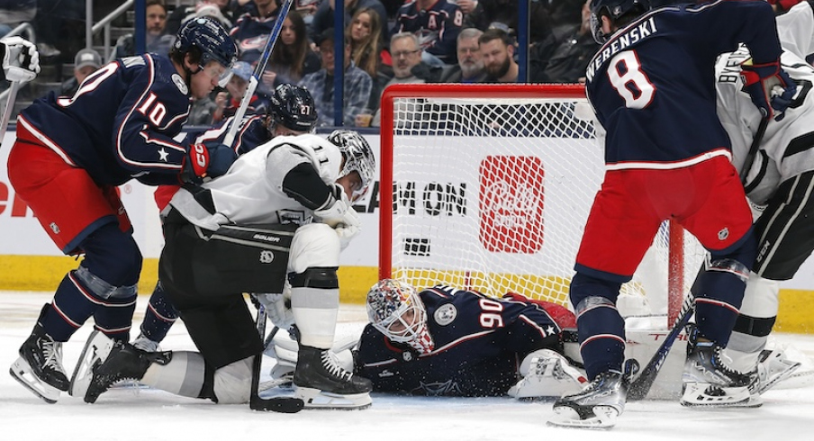 Columbus Blue Jackets' Elvis Merzlikins covers a loose puck as Los Angeles Kings' Anze Kopitar looks for the rebound during the second period at Nationwide Arena.