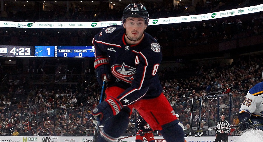 Columbus Blue Jackets defenseman Zach Werenski (8) tracks down a loose puck against the St. Louis Blues during the first period at Nationwide Arena.