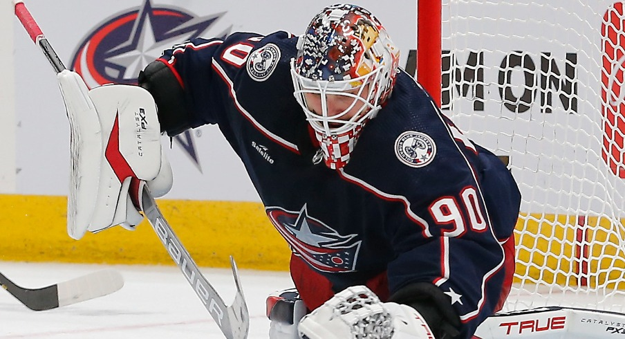 Columbus Blue Jackets goalie Elvis Merzlikins (90) reaches for a loose puck against the Los Angeles Kings during the second period at Nationwide Arena.