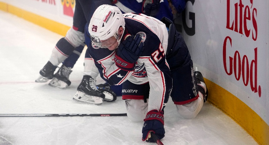 Columbus Blue Jackets forward Patrik Laine (29) grabs his shoulder after being upended by Toronto Maple Leafs defenseman William Lagesson (85) during the second period at Scotiabank Arena.