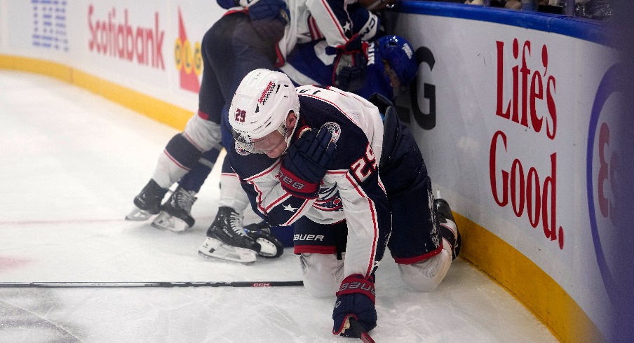 Columbus Blue Jackets forward Patrik Laine (29) grabs his shoulder after being upended by Toronto Maple Leafs defenseman William Lagesson (85) during the second period at Scotiabank Arena.