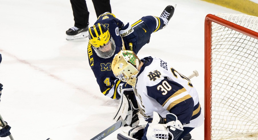 Notre Dame goaltender Ryan Bischel (30) makes the save on shot by Michigan forward Gavin Brindley (4) during the Michigan-Notre Dame NCAA hockey game on Saturday, November 12, 2022, at Compton Family Ice Arena in South Bend, Indiana. Michigan Vs Notre Dame