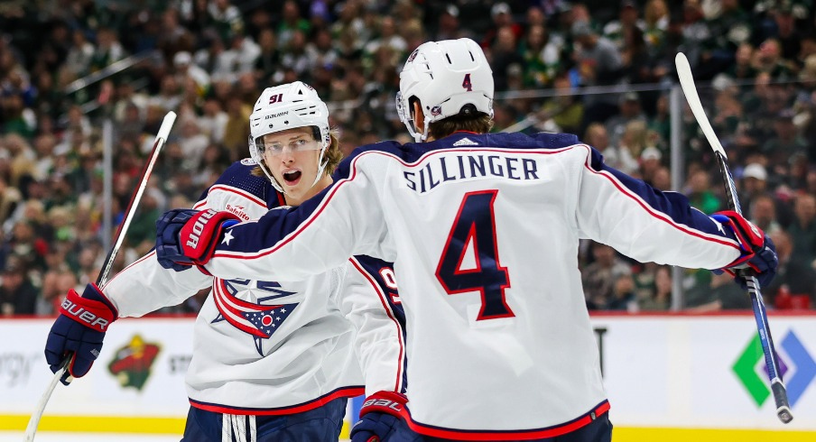 Columbus Blue Jackets center Kent Johnson (91) celebrates his goal against the Minnesota Wild with teammates center Cole Sillinger (4) and defenseman Damon Severson (78) during the second period at Xcel Energy Center.